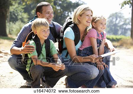 Stock Image - Young family on country walk. Fotosearch