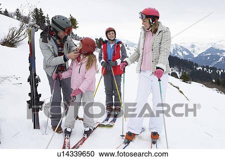 Stock Image - Young Family On Ski Vacation. Fotosearch