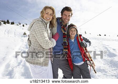 Stock Image - Young Family On Winter Vacation. Fotosearch