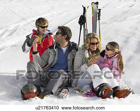 Young Family Sharing A Picnic On Ski Vacation View Large Photo Image Stock Image - Young Family Sharing A Picnic On Ski Vacation. Fotosearch
