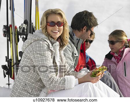 Young Family Sharing A Picnic On Ski Vacation View Large Photo Image Stock Photo - Young Family Sharing A Picnic On Ski Vacation. Fotosearch