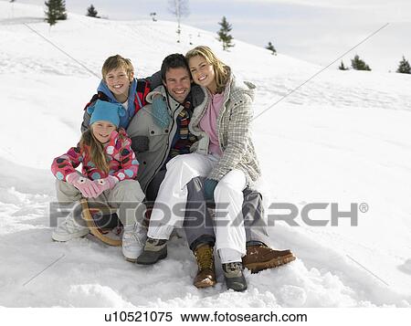 Young Family Sitting On A Sled In The Snow View Large Photo Image Stock Photography - Young Family Sitting On A Sled In The Snow. Fotosearch