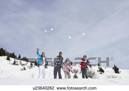 Young Family Throwing Snowballs On Winter Vacation View Large Photo Image Stock Image - Young Family Throwing Snowballs On Winter Vacation. Fotosearch