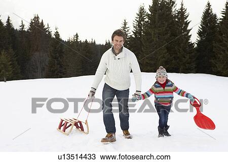 Young Father And Daughter Walking In Snow With Sleds View Large Photo Image Stock Image - Young Father And Daughter Walking In Snow With Sleds. Fotosearch