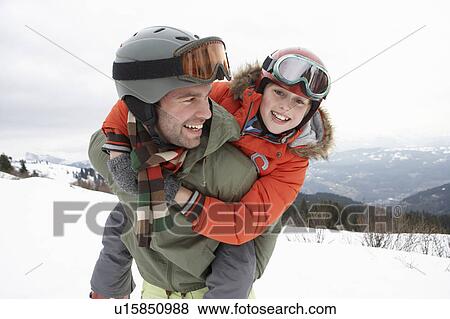 Stock Photo - Young Father And Son On Winter Vacation. Fotosearch