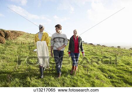 Young friends on country walk View Large Photo Image Stock Photography - Young friends on country walk. Fotosearch