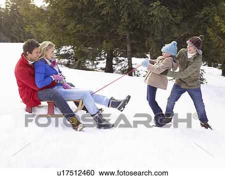 Young Girl And Boy Pulling Parents Through Snow On Sled View Large Photo Image Stock Image - Young Girl And Boy Pulling Parents Through Snow On Sled. Fotosearch