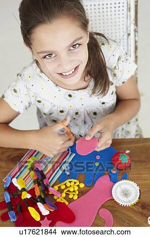 Picture - Young girl doing handicrafts. Fotosearch