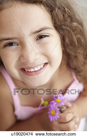 Picture - Young girl holding flowers. Fotosearch