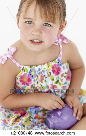 Young girl with piggy bank View Large Photo Image Stock Photo - Young girl with piggy bank. Fotosearch