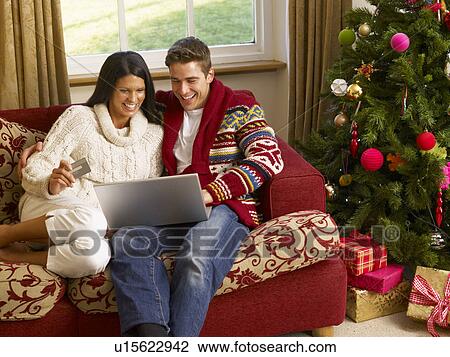 Young Hispanic couple Christmas shopping online View Large Photo Image Stock Image - Young Hispanic couple Christmas shopping online. Fotosearch