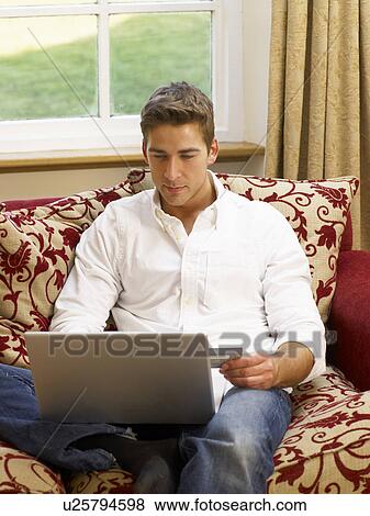 Stock Photo - Young Hispanic couple shopping online. Fotosearch