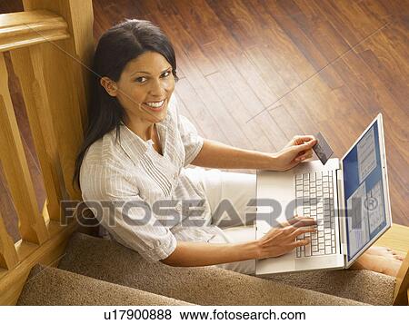 Young Hispanic woman shopping online View Large Photo Image Stock Photo - Young Hispanic woman shopping online. Fotosearch