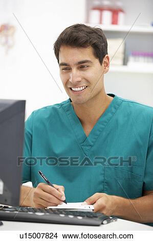 Young hospital doctor at desk View Large Photo Image Picture - Young hospital doctor at desk. Fotosearch