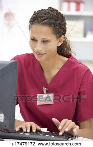 Young hospital doctor at desk View Large Photo Image Stock Image - Young hospital doctor at desk. Fotosearch