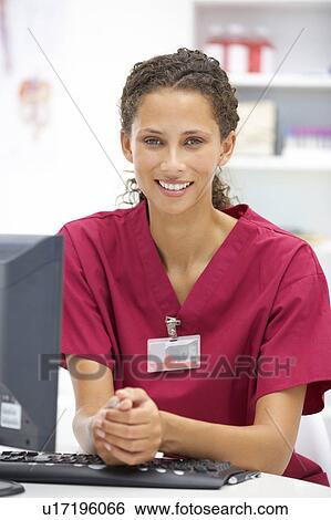 Young hospital doctor at desk View Large Photo Image Stock Photograph - Young hospital doctor at desk. Fotosearch