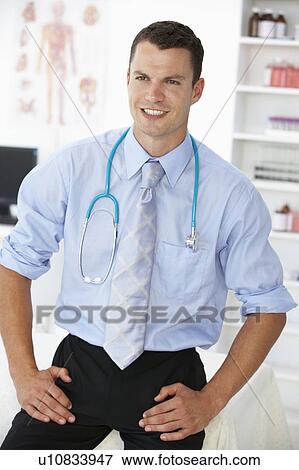 Young male doctor in consulting room View Large Photo Image Stock Photo - Young male doctor in consulting room. Fotosearch