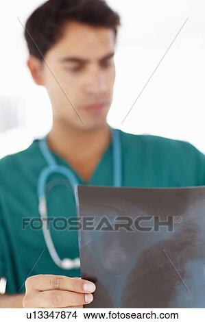 Young male doctor with x-ray View Large Photo Image Picture - Young male doctor with x-ray. Fotosearch