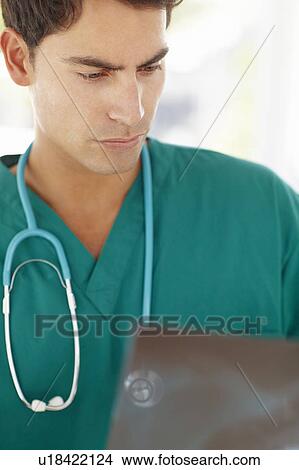 Young male doctor with x-ray View Large Photo Image Picture - Young male doctor with x-ray. Fotosearch