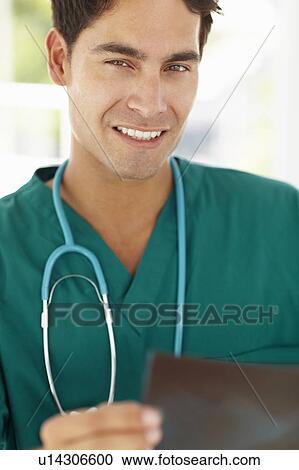 Stock Image - Young male doctor with x-ray. Fotosearch
