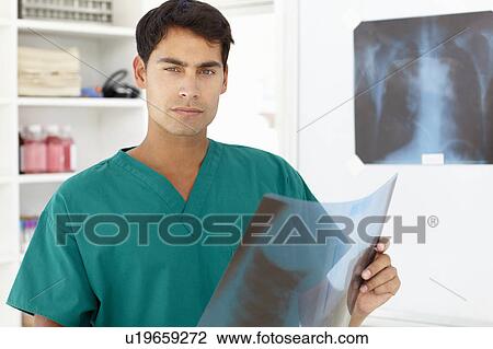 Stock Image - Young male doctor with x-ray. Fotosearch