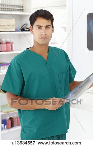 Stock Photo - Young male doctor with x-ray. Fotosearch
