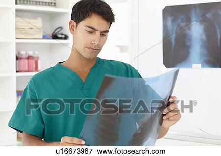 Stock Photo - Young male doctor with x-ray. Fotosearch