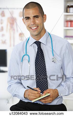 Young male doctor writing prescription View Large Photo Image Stock Image - Young male doctor writing prescription. Fotosearch