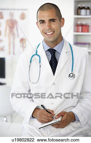 Young male doctor writing prescription View Large Photo Image Stock Image - Young male doctor writing prescription. Fotosearch