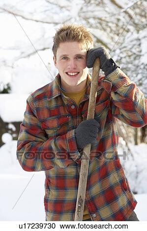 Young man clearing snow View Large Photo Image Stock Image - Young man clearing snow. Fotosearch