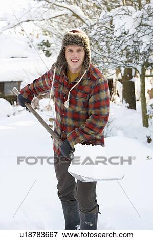 Young man clearing snow View Large Photo Image Stock Photo - Young man clearing snow. Fotosearch