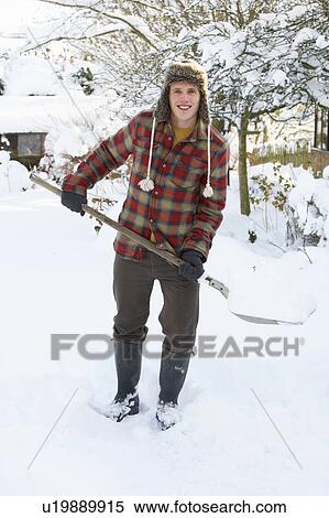 Young man clearing snow View Large Photo Image Stock Photography - Young man clearing snow. Fotosearch