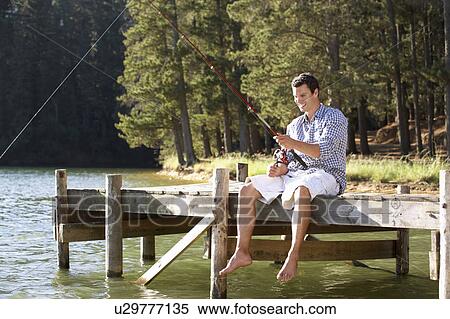 Stock Photography - Young man fishing. Fotosearch