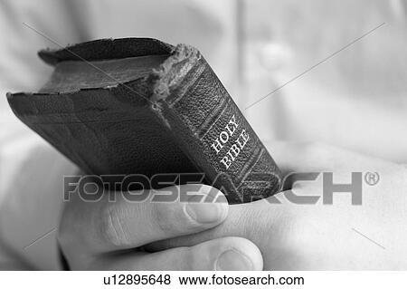 Stock Photo - Young man holding bible. Fotosearch