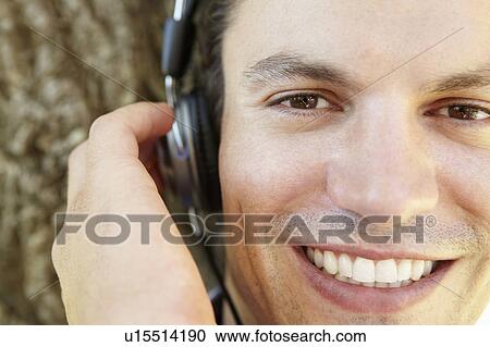 Stock Image - Young man listening music. Fotosearch