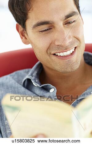 Young man reading a book View Large Photo Image Stock Photography - Young man reading a book. Fotosearch