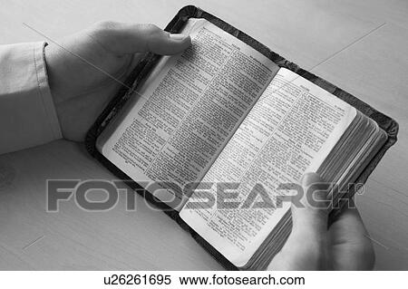 Stock Photography - Young man reading bible. Fotosearch