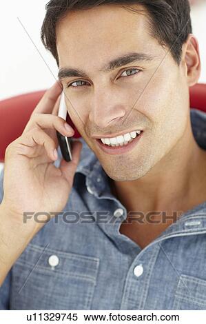 Young man talking on the phone View Large Photo Image Stock Photography - Young man talking on the phone. Fotosearch