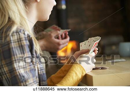 Stock Photography - Young people playing cards. Fotosearch