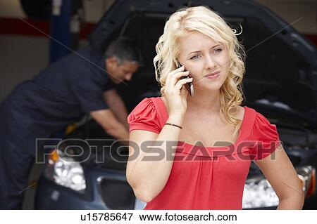 Young woman at auto repair shop View Large Photo Image Stock Photo - Young woman at auto repair shop. Fotosearch