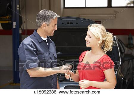 Young woman collecting care from repair shop View Large Photo Image Stock Photograph - Young woman collecting care from repair shop. Fotosearch