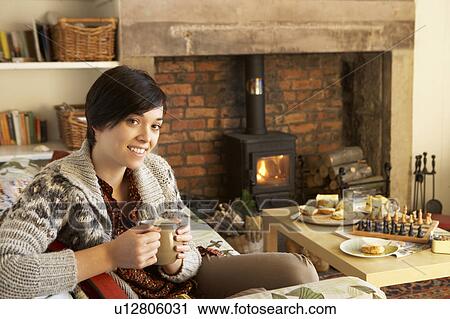 Young woman having tea by fire View Large Photo Image Stock Image - Young woman having tea by fire. Fotosearch