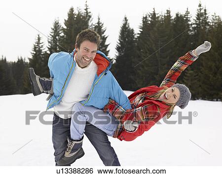 Stock Photograph - Young Woman In Alpine Snow Scene. Fotosearch