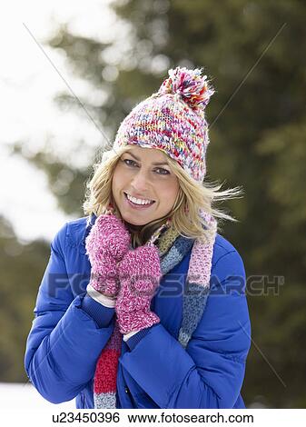 Stock Photograph - Young Woman In Alpine Snow Scene. Fotosearch