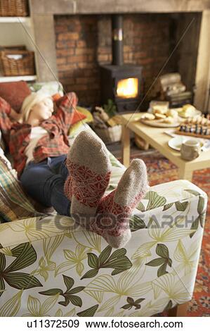 Young woman relaxing by fire View Large Photo Image Stock Photo - Young woman relaxing by fire. Fotosearch