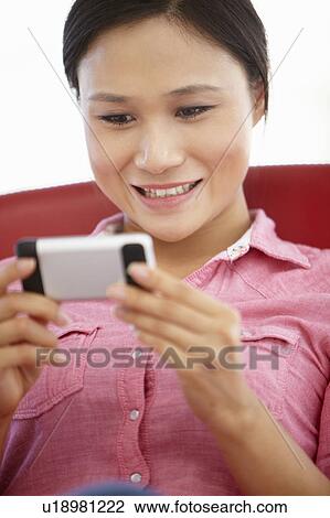 Young woman texting View Large Photo Image Stock Image - Young woman texting. Fotosearch