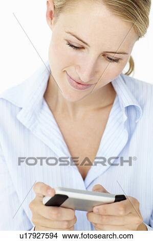 Picture - Young woman using mobile phone. Fotosearch