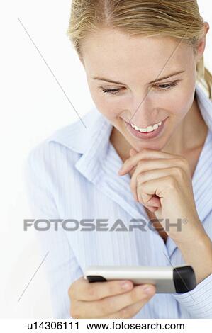 Young woman using mobile phone View Large Photo Image Stock Image - Young woman using mobile phone. Fotosearch