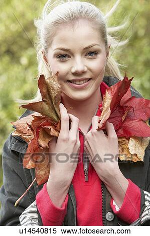 Young woman with autumn leaves View Large Photo Image Stock Photography - Young woman with autumn leaves. Fotosearch