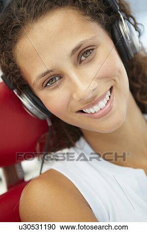 Young woman with headphones View Large Photo Image Stock Image - Young woman with headphones. Fotosearch